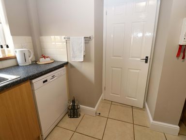 A kitchen with a kettle and dishwasher at Amblers Rest in Amble