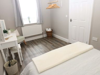 A bedroom featuring a bed and desk at Amblers Rest in Amble