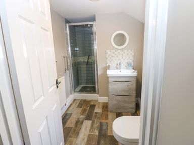 A bathroom with a shower and sink at Amblers Rest in Amble