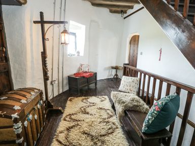 A snug room with a chest and seating at The Old Cornmill in Cemaes Bay