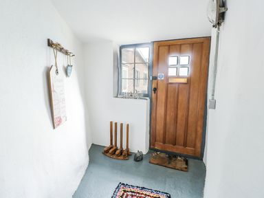 An entrance hall with a door and a window at The Old Cornmill in Cemaes Bay