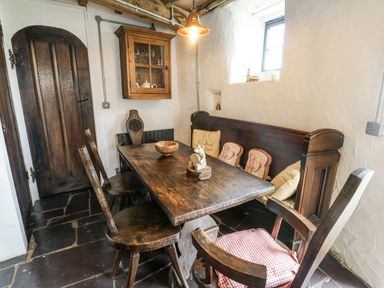 A dining room with a table and chairs at The Old Cornmill in Cemaes Bay