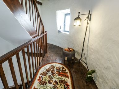 A stairway with a window and a lamp at The Old Cornmill in Cemaes Bay