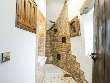 A bathroom with a shower, toilet, and sink at The Old Cornmill in Cemaes Bay