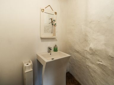 A bathroom with a washbasin and mirror at The Old Cornmill in Cemaes Bay