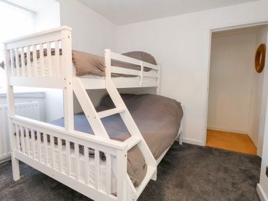 A bedroom with a bunk bed in The Beach Condo in Weymouth
