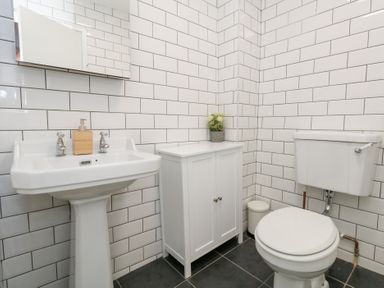 A bathroom with a sink and toilet at The Beach Condo in Weymouth