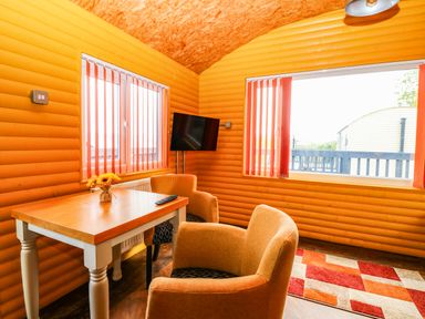 A snug with a table and chairs at Ava Lodge in West Mains near Haggerston