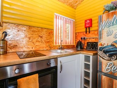 A kitchen with a sink, stove, and refrigerator at Ava Lodge, West Mains near Haggerston