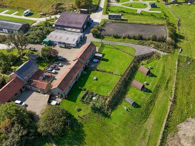 An outdoor view of a farm with buildings and grassy areas at Mini pod Staintondale near Burniston