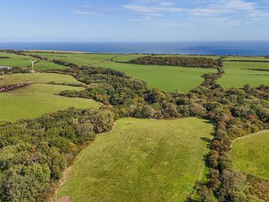 Landscape featuring wind turbine and fields at Mini pod Staintondale near Burniston