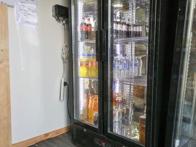 A refrigerator with drinks inside at Woodpeckers Shepherds hut Staintondale near Burniston