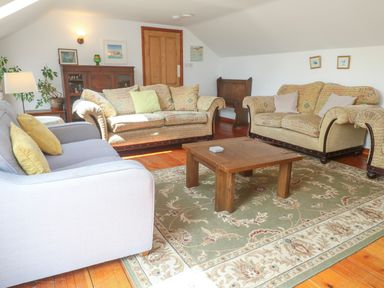 A living room with sofas and a coffee table at The Cottage in St. Ives