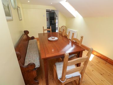 A dining room with a table and chairs at The Cottage in St. Ives