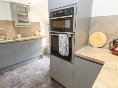 A kitchen with oven and sink at The Cottage St. Ives