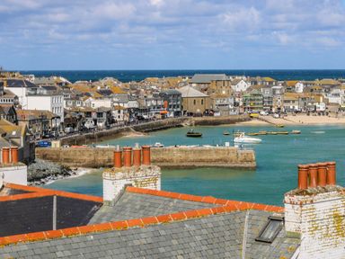 A view of a harbor with buildings and boats at The Cottage in St. Ives