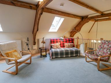 A living room with a sofa, armchairs and a coffee table at Yr Hen Ysgoldy