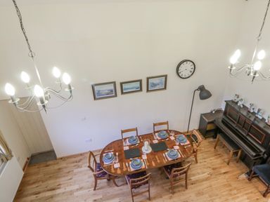 A dining room with a table set for dinner at Yr Hen Ysgoldy