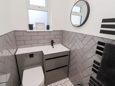 A bathroom with a sink and toilet at Rose Cottage in Dunstan near Embleton