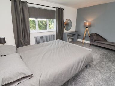 A bedroom with a bed and a desk at Rose Cottage in Dunstan near Embleton