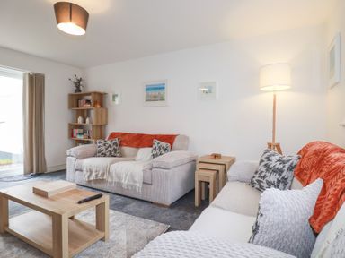 A living room with a sofa and coffee table at Poldam St Austell