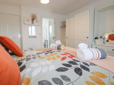 A bedroom with a bed and wardrobe at Poldam St Austell