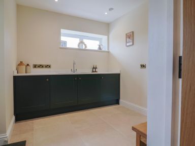 A kitchen with cabinets and a sink at Foxes Den in Pendomer near Yeovil, Somerset
