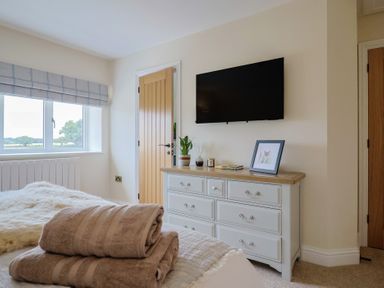 A bedroom with a bed and dresser at Foxes Den Pendomer near Yeovil Somerset