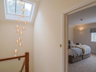 A bedroom with a bed and window at Foxes Den Pendomer near Yeovil, Somerset