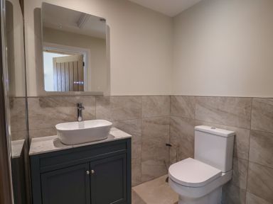 A bathroom with a sink and toilet at The Fox Den in East Coker