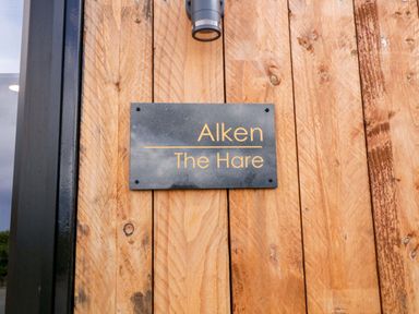 A sign on a wooden wall at Alken The Hare in Bushmills
