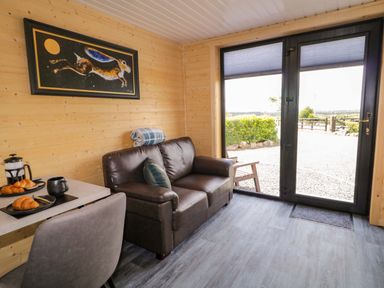 A snug with a sofa and coffee table at Alken The Hare in Bushmills