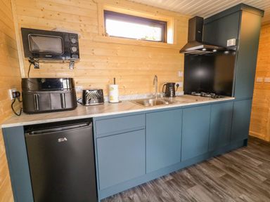 A kitchen with appliances and cabinets at Alken The Hare in Bushmills