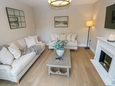 A living room with sofas and a coffee table at Hafan Y Gof in Newcastle Emlyn