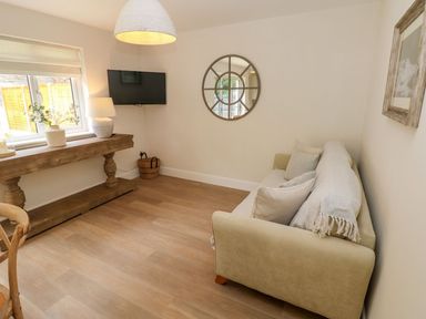 A sitting room with a sofa and a table at Hafan Y Gof in Newcastle Emlyn