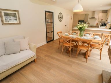 A dining room with a table set for dinner at Hafan Y Gof Newcastle Emlyn