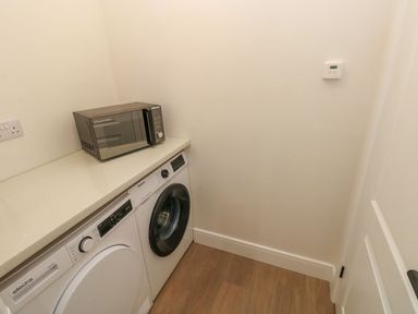 A laundry room with a washer and dryer at Hafan Y Gof in Newcastle Emlyn