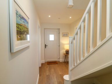 A hallway with a door and lamp at Hafan Y Gof in Newcastle Emlyn