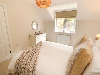 A bedroom with a bed and dresser at Hafan Y Gof in Newcastle Emlyn