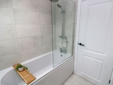 A bathroom with a bathtub and shower in Hafan Y Gof Newcastle Emlyn