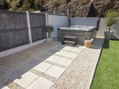 A garden area with a hot tub and steps at Hafan Y Gof in Newcastle Emlyn