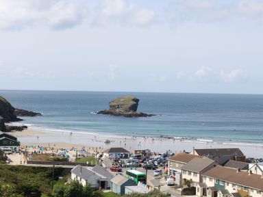 A beach with people and buildings at Carn Brea in Redruth