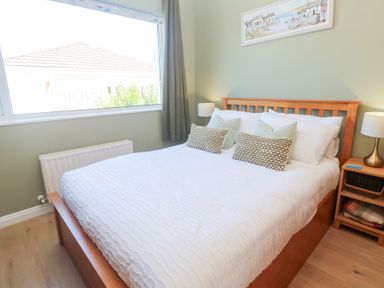 A bedroom with a bed and bedside lamps at Carn Brea in Redruth