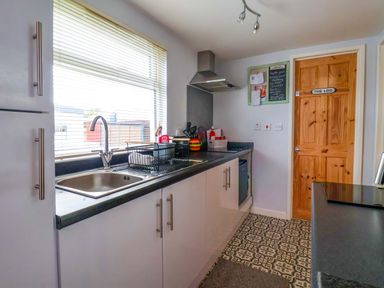 A kitchen with a sink and stove at Chalet 231 in Bridlington