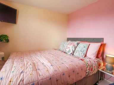 A bedroom with a bed and television at Chalet 231 in Bridlington
