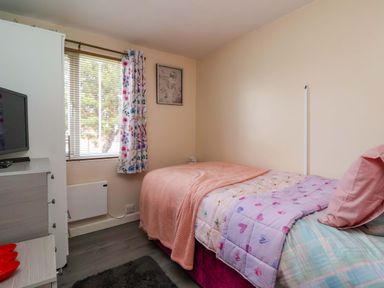 A bedroom with a bed and television at Sandbay in Bridlington