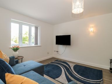 A living room with a sofa and television at 1 The Stables Highbridge