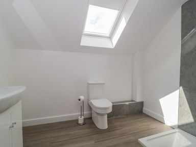 A bathroom with a toilet and sink at 1 The Stables, Highbridge