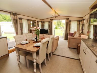 A living room with a dining area and sofa at 22 Yealand in Carnforth