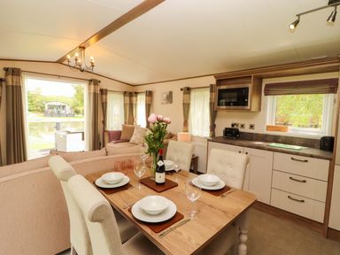 A dining area with table and chairs at 22 Yealand in Carnforth